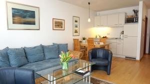 a living room with a couch and chairs and a table at Appartements Haus Tannenburg in Ahlbeck