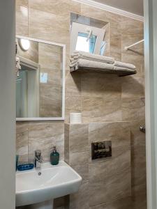 a bathroom with a sink and a mirror at Morskyi 487 in Zatoka +51 photos