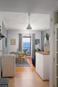 a living room and dining room with a view of the ocean at Beach front Apartment in Podgora