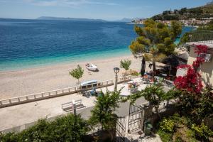 a view of a beach with a boat in the water at Beach front Apartment in Podgora