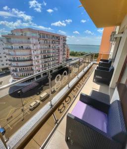 einen Balkon mit Blick auf das Meer und die Gebäude in der Unterkunft Sunset Sea View Apartament in Mamaia