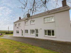 a white house with white windows and a driveway at Bryngwyn in Haverfordwest