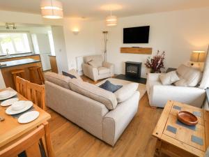 a living room with two couches and a table at Bryngwyn in Haverfordwest