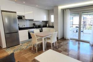 kuchnia ze stołem i krzesłami oraz kuchnia z lodówką w obiekcie Modern Two Bedroom Apartment in Marbella Centre w Marbelli