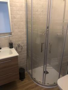 a bathroom with a glass shower and a sink at La Rosa Apartment Los Boliches Fuengirola Malaga Spain in Fuengirola