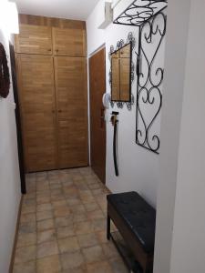 a hallway with a door and a bench in a room at Apartmán Jan in Břeclav