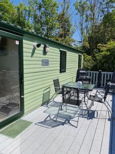 a patio with a table and chairs on a house at Nicks, next door to Carmels in Carnforth