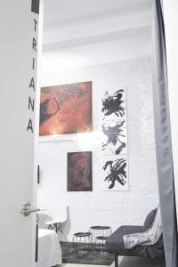 a living room with art on the wall at Triana modern & luxury in Seville