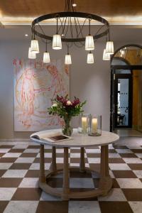 a table with flowers and candles on a checkered floor at Villa Dagmar in Stockholm +49 photos