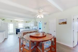 a kitchen and dining room with a table and chairs at 1 Sand Dollar in Holden Beach