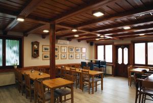 a dining room with wooden tables and chairs at Penzion U Vlků in Valtice