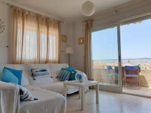 a living room with a white couch and a large window at Sector 5 Napols AP844 in Oliva
