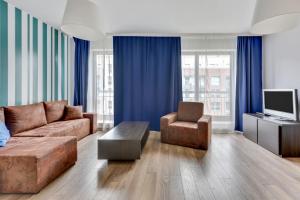 salon z kanapą i telewizorem w obiekcie Grand Apartments - Szafuza Apartment Gdańsk Szafarnia w Gdańsku