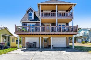 a large house with a balcony and a deck at Spacious Seaside Home with an Ocean View in Seaside