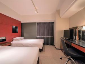 Ліжко або ліжка в номері Hotel Vista Sapporo Nakajima Koen