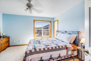 a bedroom with a bed and a window at Spacious Seaside Home with an Ocean View in Seaside