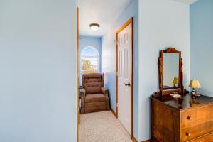 a room with a mirror and a chair and a dresser at Spacious Seaside Home with an Ocean View in Seaside