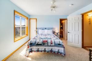 a bedroom with a bed and a window at Spacious Seaside Home with an Ocean View in Seaside