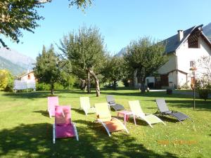a group of lawn chairs sitting in the grass at La Marmotte De La Meije in Le Bourg-dʼOisans +2 photos