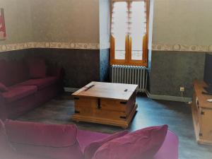 a living room with a couch and a coffee table at La Marmotte De La Meije in Le Bourg-dʼOisans