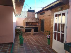 a patio with a brick fireplace in a building at Los Jazmines II in Tandil