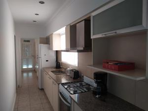 a kitchen with a stove and a counter top at Los Jazmines II in Tandil