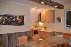 a kitchen with a table and a counter top at Villam Apartment in Maribor