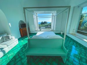 a bedroom with two beds and a window at Il Carrubo Capri in Anacapri