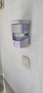 a wall with a soap dispenser on a wall at Bungalow Carpe Diem wifi in Torrevieja