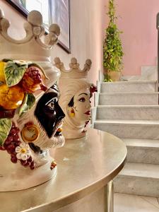 a vase sitting on a table next to some stairs at Hotel Scilla in Scilla
