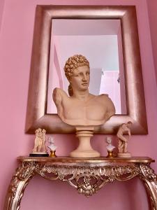 a bust of a woman in a mirror on a shelf at Hotel Scilla in Scilla