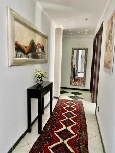 a hallway with a table and a painting on the wall at Hotel Scilla in Scilla