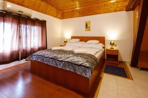 a bedroom with a large bed in a room at Central Panzió Gyula in Gyula