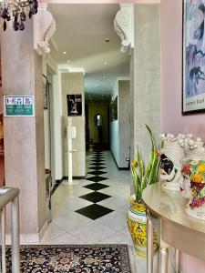 a hallway with a checkerboard floor in a building at Hotel Scilla in Scilla