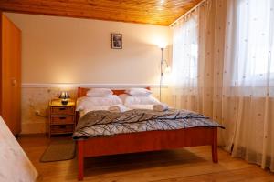 a bedroom with a bed with two pillows at Central Panzió Gyula in Gyula