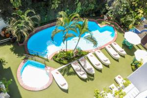 an overhead view of a resort pool with lounge chairs at Los Arcos Suites in Puerto Vallarta