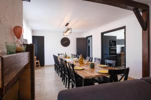 a dining room with a long table and chairs at Gîte La Parenthèse 14 personnes in Loisy-sur-Marne