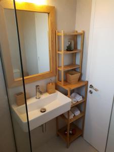 a bathroom with a sink and a mirror at Villa Clio in Mánganos +64 photos