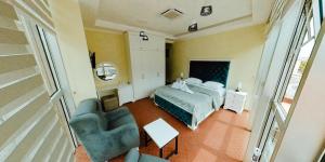 a bedroom with a bed and a chair and a table at Diamond Hotel & Restaurant Ulcinj in Ulcinj