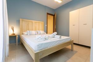 a bedroom with a bed with towels on it at Alexa's Sunny Days in Limenaria +77 photos