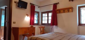 Postel nebo postele na pokoji v ubytování Hotel Cristallo