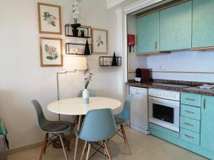 a kitchen with a table and chairs in a room at Amatista 110 in Calpe