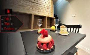 a table with a cake and two glasses of wine at Studio Zen Tokyo in Lyon
