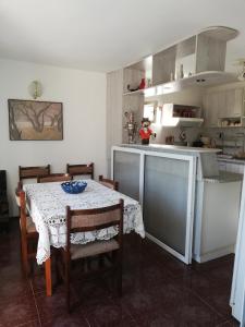 a kitchen with a table and some chairs and a table and a kitchen at Villa Trakia in Golden Sands
