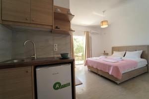 a kitchen with a bed with a sink and a counter at Meltemi in Parga +72 photos