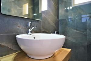 a bathroom with a white sink and a mirror at Meltemi in Parga