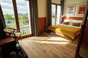 a bedroom with a bed and a large window at The People - Paris Nation in Paris