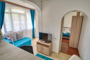 a living room with a tv and a bedroom at Apartments Suster in Bar