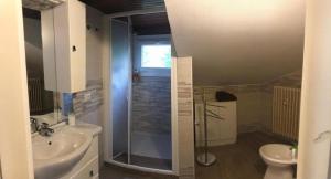 a bathroom with a shower and a toilet and a sink at Appartamento la mansarda in Lecco