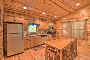 een keuken met een houten tafel en een koelkast bij The Mountain Laurel Sautee Mountain Retreat in Clarkesville